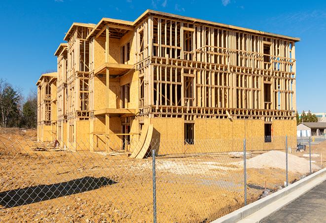 a close-up of temporary chain link fences enclosing a construction site, signaling progress in the project's development in Effie, LA